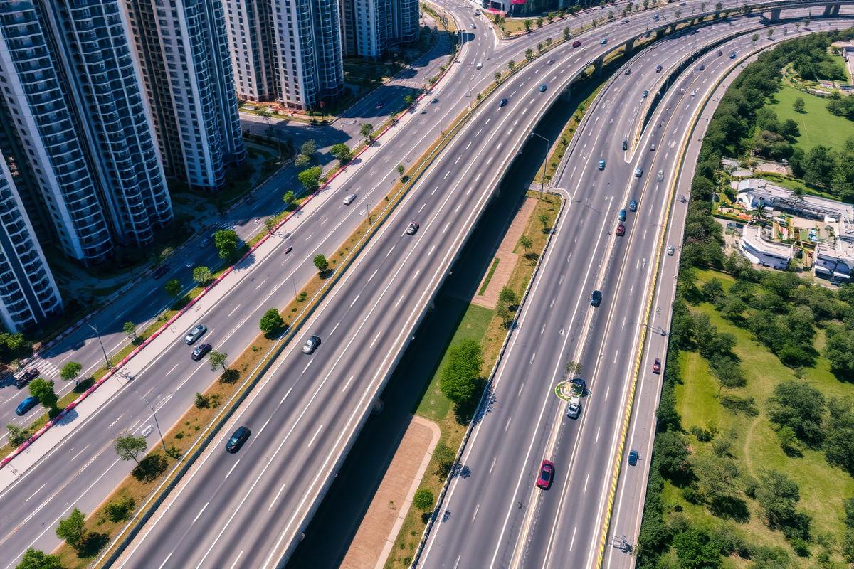 Aerial view of a Gurugram expressway corridor lined with residential towers